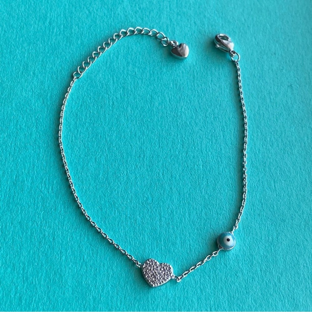Silver stainless steal evil eye bracelet with heart.